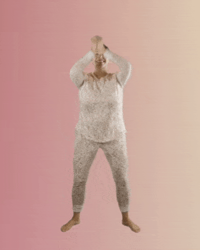 a woman in pajamas doing victory squats