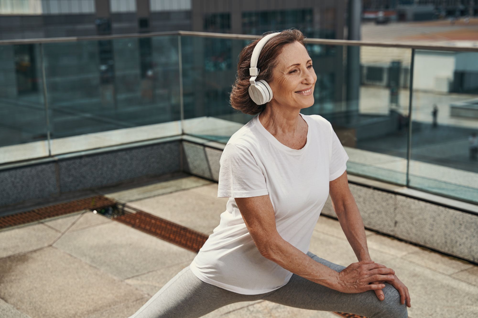 a happy active woman exercising on the rooftop