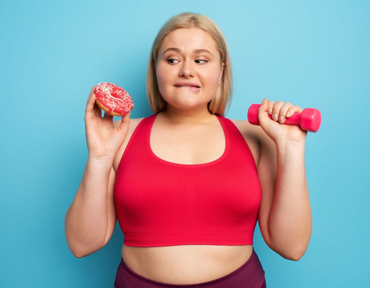 A lady holding a dumbel and a doughnut, weghin options