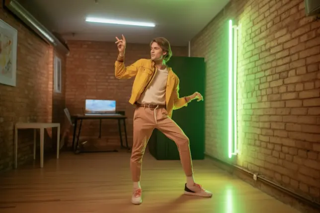 A rejuvenated guy dancing in his stylish office knowing how to rejuvenate